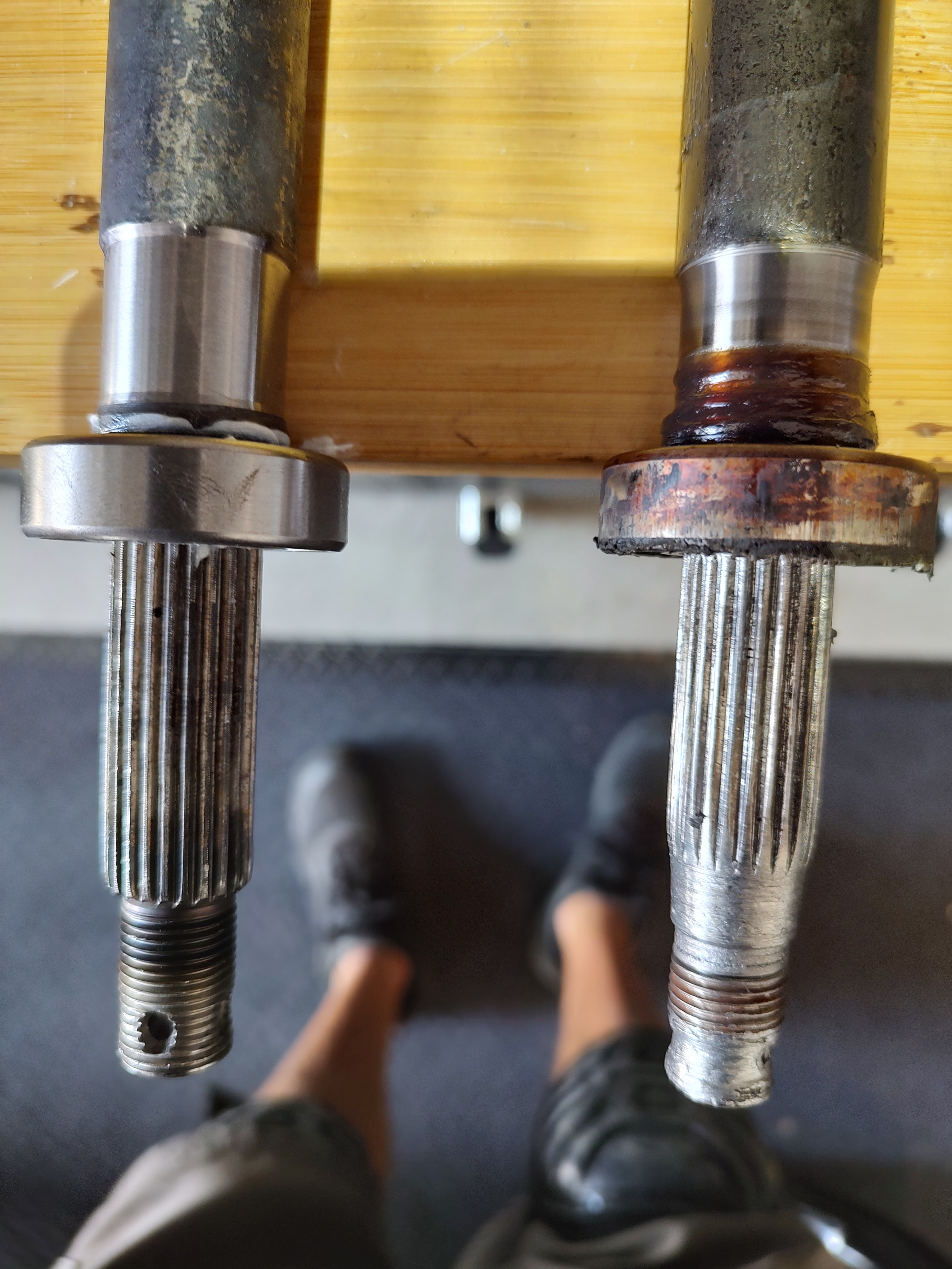 Worn vs new golf cart axle spindle comparison