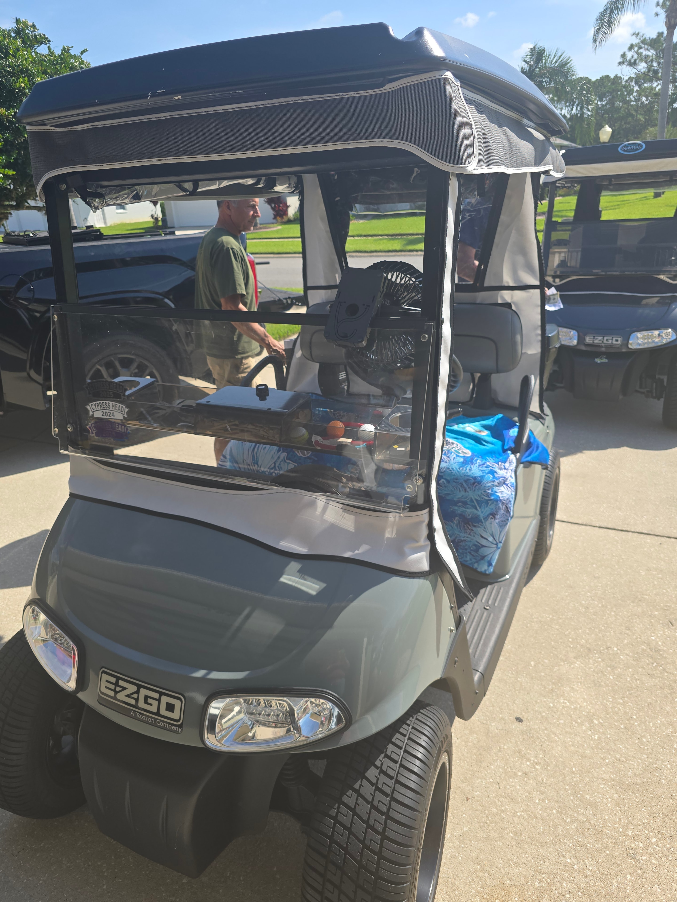 Grey EZ-GO golf cart front view outdoors